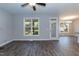 Bright living room featuring wood floors, ceiling fan and access to backyard through glass door at 3001 Sadie Hopkins St, Raleigh, NC 27616
