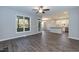 Open-concept living space featuring wood floors and a view into the kitchen and backyard at 3001 Sadie Hopkins St, Raleigh, NC 27616