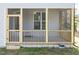 The spacious screened porch has natural wood trim and a door for easy access at 3001 Sadie Hopkins St, Raleigh, NC 27616