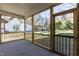 A cozy screened porch with wood railings and a view of the fenced-in backyard at 3001 Sadie Hopkins St, Raleigh, NC 27616