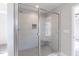 Modern shower with frameless glass enclosure, gray tile, and a built-in bench at 3001 Sadie Hopkins St, Raleigh, NC 27616