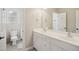 Bathroom featuring a double sink vanity with white cabinets and a shower-tub combo in an alcove at 4001 Falls River Ave, Raleigh, NC 27614
