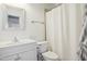Bathroom features a single sink vanity with a shower-tub combo and a large mirror at 4001 Falls River Ave, Raleigh, NC 27614