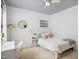 Bright bedroom features a ceiling fan, carpet, natural light, and is staged with contemporary décor at 4001 Falls River Ave, Raleigh, NC 27614