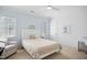 Bedroom with blue accent wall, ceiling fan, white trim and carpeted flooring at 4001 Falls River Ave, Raleigh, NC 27614