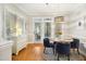 Bright dining room featuring a round table, blue chairs, hardwood floors, and a decorative light fixture at 4001 Falls River Ave, Raleigh, NC 27614