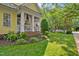 Well-manicured front yard with lush lawn, landscaping, and a charming white picket fence at 4001 Falls River Ave, Raleigh, NC 27614