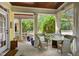 Cozy covered porch with wicker chairs, blue accents, and views of lush greenery at 4001 Falls River Ave, Raleigh, NC 27614