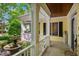 Covered porch with white columns, a water fountain, and views of the landscaped yard at 4001 Falls River Ave, Raleigh, NC 27614