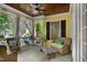 Relaxing porch featuring wicker furniture, decorative pillows, and a wooden ceiling fan at 4001 Falls River Ave, Raleigh, NC 27614