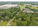 Scenic aerial view featuring homes surrounded by lush trees and roadways, offering a peaceful environment at 402 Forest Rd, Oxford, NC 27565