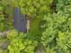 Aerial view of a home with mature trees, a backyard patio and roof at 402 Forest Rd, Oxford, NC 27565