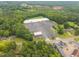 Aerial view showing a shopping center, surrounded by trees, providing convenient access to amenities at 402 Forest Rd, Oxford, NC 27565