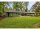 Spacious backyard featuring a well-maintained lawn, mature trees, and a patio area perfect for outdoor gatherings at 402 Forest Rd, Oxford, NC 27565