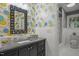 Quaint bathroom with stylish wallpaper, black vanity, and walk-in shower at 402 Forest Rd, Oxford, NC 27565