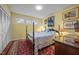 Comfortable bedroom with a cozy four-poster bed and ample natural light at 402 Forest Rd, Oxford, NC 27565