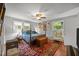 Comfortable bedroom with a four-poster bed, ceiling fan, and a view of the outdoors at 402 Forest Rd, Oxford, NC 27565