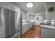 Bright kitchen features stainless steel appliances, grey cabinetry, granite counters and eat-in dining at 402 Forest Rd, Oxford, NC 27565