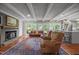 Inviting living area with fireplace, beamed ceilings and views into the back yard at 402 Forest Rd, Oxford, NC 27565