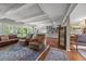 Inviting living area with beamed ceilings, leading to the kitchen and featuring hardwood floors at 402 Forest Rd, Oxford, NC 27565