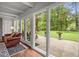 Bright living room with large windows offers a beautiful view of the well-maintained backyard at 402 Forest Rd, Oxford, NC 27565