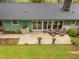 Overhead view of the patio with mature landscaping, a cozy seating area, and sliding glass doors at 402 Forest Rd, Oxford, NC 27565