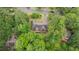 Here is an aerial view of a brick home with lush greenery and a well-maintained yard in a wooded neighborhood at 414 Bakewell Ct, Wake Forest, NC 27587