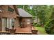 Covered brick patio with brick pillars, rocking chair and a view of the back yard at 414 Bakewell Ct, Wake Forest, NC 27587