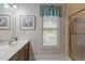 Bright bathroom featuring vanity with sink, large mirror and window at 414 Bakewell Ct, Wake Forest, NC 27587