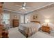 Cozy bedroom featuring warm paint and floral wallpaper, soft carpet, and ample natural light at 414 Bakewell Ct, Wake Forest, NC 27587