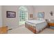 Spacious bedroom featuring a large window with backyard view, carpeted floors, and a neutral color palette at 414 Bakewell Ct, Wake Forest, NC 27587