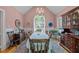 Elegant dining room with a large window, chandelier, and traditional furniture at 414 Bakewell Ct, Wake Forest, NC 27587
