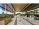 Inviting entrance with seating, greenery, and a covered walkway into the building at 414 Bakewell Ct, Wake Forest, NC 27587