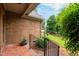 Brick patio with black railing overlooking a landscaped yard at 414 Bakewell Ct, Wake Forest, NC 27587