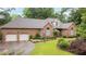 Charming brick home with a well-manicured lawn, a two-car garage, and an inviting front facade at 414 Bakewell Ct, Wake Forest, NC 27587