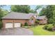 Traditional brick home featuring manicured landscaping, a two-car garage, and an American flag at 414 Bakewell Ct, Wake Forest, NC 27587