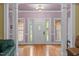 Bright foyer featuring hardwood floors, a white front door, and columns at 414 Bakewell Ct, Wake Forest, NC 27587