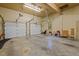 Spacious garage with two garage doors and a side door, concrete floor and painted walls at 414 Bakewell Ct, Wake Forest, NC 27587