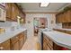 Charming kitchen featuring warm wood cabinetry, white countertops and a view into the breakfast room at 414 Bakewell Ct, Wake Forest, NC 27587