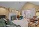 Cozy living room with a fireplace, neutral carpet, and comfortable seating at 414 Bakewell Ct, Wake Forest, NC 27587