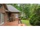 Lovely outdoor patio space features brick floors and peaceful seating area surrounded by mature trees at 414 Bakewell Ct, Wake Forest, NC 27587