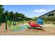 Fun playground features a red cardinal sculpture, green umbrellas, and caterpillar-shaped climbing structures at 414 Bakewell Ct, Wake Forest, NC 27587
