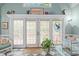 Bright sunroom with french doors, plants, and decor at 414 Bakewell Ct, Wake Forest, NC 27587