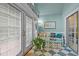 Bright sunroom with french doors, tile floor, seating and decor at 414 Bakewell Ct, Wake Forest, NC 27587