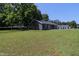 Spacious backyard with well-maintained lawn and gray home at 420 E Grandview Ave, Liberty, NC 27298