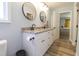 Spacious bathroom featuring double vanity sinks and granite countertops with access to the main bedroom at 420 E Grandview Ave, Liberty, NC 27298