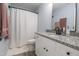 Bright bathroom features granite counters, white cabinets, and a shower-tub combo at 420 E Grandview Ave, Liberty, NC 27298