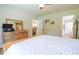 Bright bedroom featuring a wooden dresser, record player, and view into the bathroom and kitchen at 420 E Grandview Ave, Liberty, NC 27298