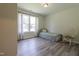 Bright bedroom features wood-look floors, a twin bed, a window, and a rocking chair at 420 E Grandview Ave, Liberty, NC 27298