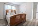 Bright bedroom features wood-look floors, a wood frame bed, a window, and closet doors at 420 E Grandview Ave, Liberty, NC 27298